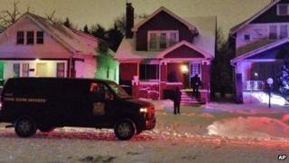 A crime scene vehicle is parked outside a house in Detroit 16 January 2014