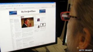 A woman reads the New York Times online.