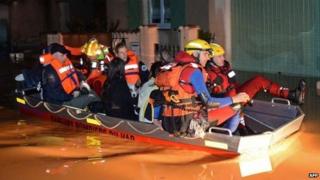Rescue workers use a boat as they evacuate people from their homes in the Oratoire neighbourhood of Hyeres-Les-Palmiers on 19 January