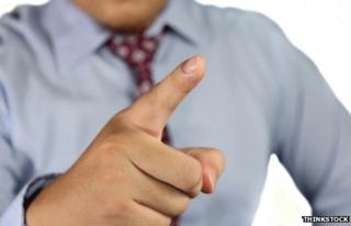 A figure in a scolding pose