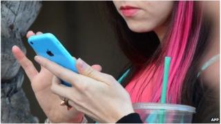 Woman uses a phone (file image)