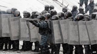 A riot police officer aims at demonstrators during clashes between protestors and police in the centre of Kiev on January 22, 2014.