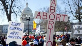 Protesters hold up signs during the January 22, 2014, March of Life in Washington, DC.