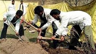 Police later exhumed the bodies of the killed men