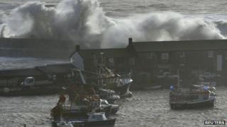 Waves crash over the Cobb at Lyme Regis