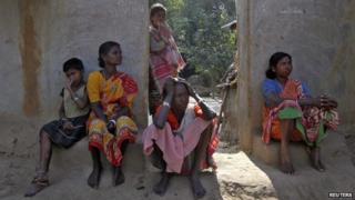 Villagers sit near the area where a woman was gang-raped at Birbhum district in the eastern Indian state of West Bengal (January 24, 2014)
