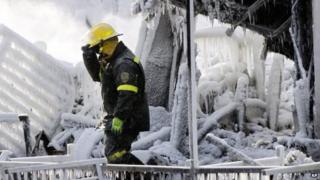 Police investigator in the rubble of fire-hit retirement home in L'Isle-Verte, Quebec (24 Jan)
