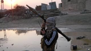 A gunman holds his weapon in Falluja, 40 miles (65km) west of Baghdad, Iraq