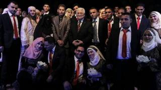 Palestinian President Mahmoud Abbas with couples in Jericho. 28 Jan 2014
