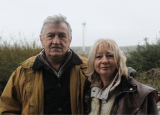 Michael and Dorothy Keane with a wind turbine in the background