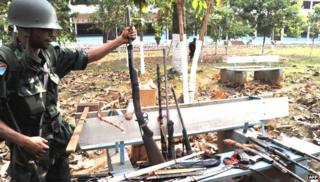 A Congolese peacekeeper displays various weapons seized from Anti-Balaka Christian militiamen in Bangui on 1 February 2014