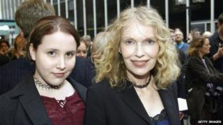 Dylan Farrow, shown with Mia Farrow in 2003, posing for a photo