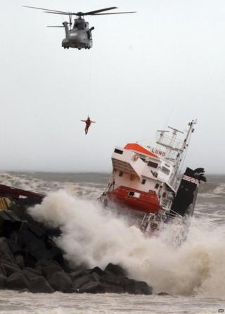 A helicopter with a man on a winch hovers near the stricken Luno, at Anglet on the French Atlantic coast, 5 February