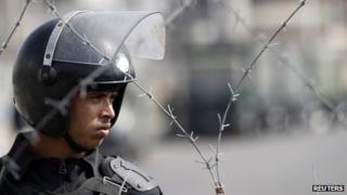 Egyptian police officer looks on at a protest