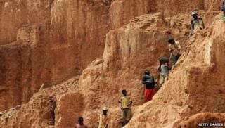 Workers up a mountain in the DR Congo