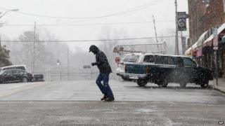A pedestrian battled the snow and wind in Sanford, North Carolina on 11 February 2014