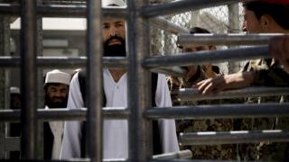 An Afghan prisoner waits in line for his release from Parwan Detention Facility after the US military gave control of its last detention facility to Afghan authorities in Bagram, on 25 March 2013.