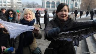 Women holding up lace panties