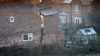 House with crack down the middle