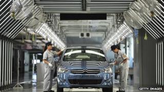Workers on the production line in a new plant of Dongfeng Peugeot-Citroën Automobile in China