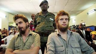 Tjostolv Moland (L) and Joshua French (R) listen to a judge reading out their sentence in Kisangani, DR Congo, on 8 September 2009