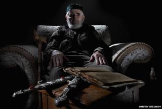 Khashiyev with daggers and a Koran