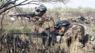 Iraqi security forces take aim during clashes with militants in Jurf al-Sakhar (15 February 2014)