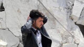 A man reacts to the destruction of his home in the Syrian city of Aleppo on 22 February, 2014