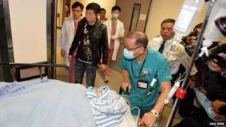 Former Ming Pao chief editor Kevin Lau is taken to an operation room in a hospital in Hong Kong, 26 February 2014