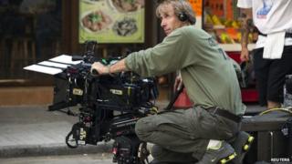 US director and producer Michael Bay holds a camera during the filming of a scene for the movie "Transformers: Age of Extinction" in Hong Kong, 24 October 2013