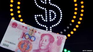 A 100-yuan banknote against the background of a US dollar sign