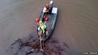 Clearing debris from Worcester bridge