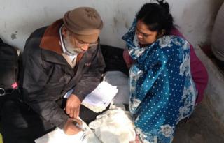 Jagdish Chandra Sharma writes address on a parcel