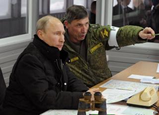 President Vladimir Putin with an army officer, 4 Mar 14