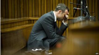Mr Pistorius holds his head in his hand on the fifth day of his trial