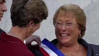 Michelle Bachelet (right) receives the presidential sash