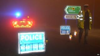 Police officer at a roadblock near the helicopter crash scene