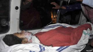 Amina Bibi, who was injured after setting herself on fire, lies in an ambulance after being taken to a hospital for treatment in Multan, Pakistan, on 13 March 2014