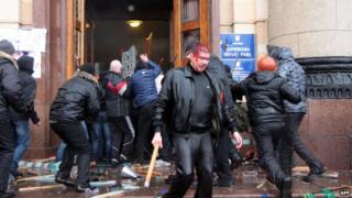 An injured man carries a club as pro-Russian activists clash with pro-Ukrainian supporters in Kharkiv. Photo: 1 March 2014