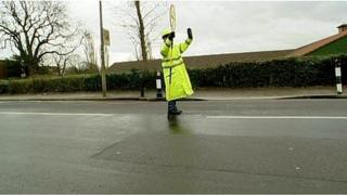 lollipop lady stopping traffic