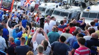A large crowd gathered in the Woodvale area of north Belfast to protest against a 12th July parade ruling