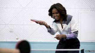 Michelle Obama plays table tennis during her visit of Beijing Normal School on 21 March 2014
