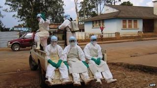 Library picture of health workers dressed in special head-to-toe Ebola suits (2005)