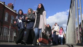 Asian women walking to Kenilworth Road football ground