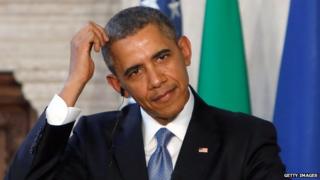 US President Barack Obama scratches his head during a press conference in Rome on 27 March, 2014.