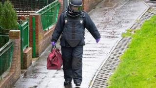 Bomb disposal officer carrying evidence away