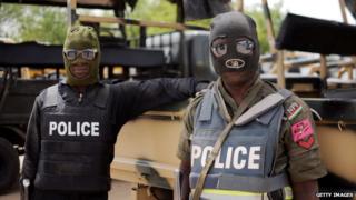 Nigerian police officers pose prior to a patrol in former Boko Haram headquarters in Maiduguri on in June 2013.