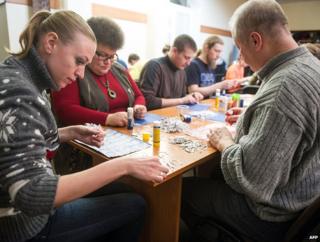 Volunteers in Kiev on 8 March 2014 piece together shredded documents found in the residence of former Ukrainian president Viktor Yanukovuch