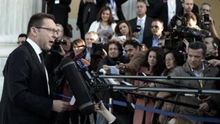 Greek Finance Minister Yiannis Stournaras with reporters in Athens, 1 Apr 14