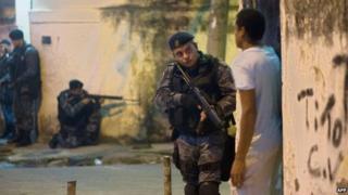 Heavily-armed police patrol a shanty town in Rio de Janeiro, on March 13, 2014